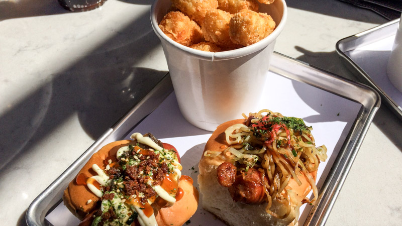 The signature Dogzilla on the left with Yaki Dog on the right with a side of tater tots, Burntzilla, Irvine