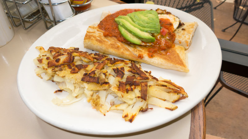Huevos Rancheros with a side of hash browns